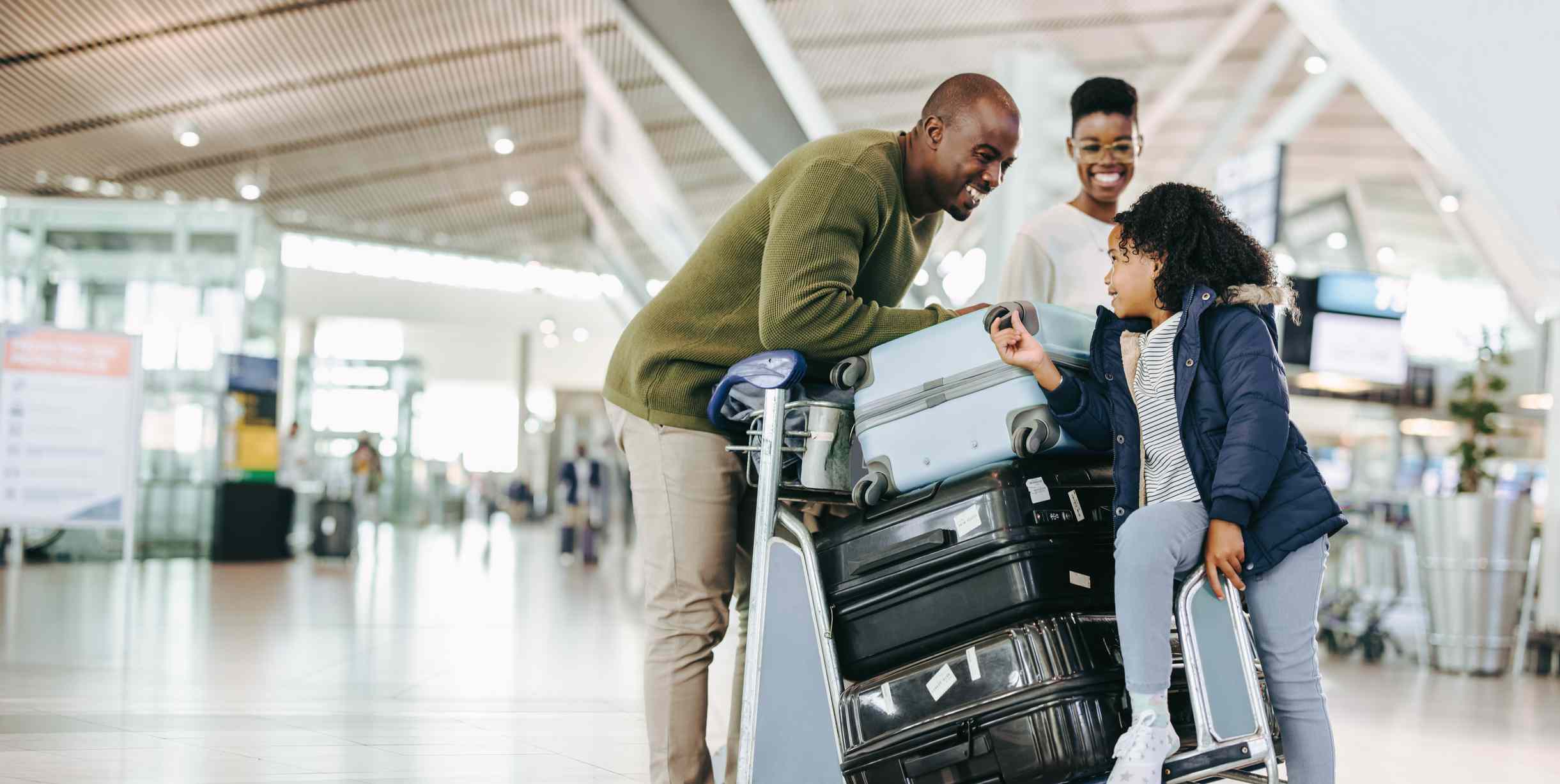 A family with a pile of luggage has a discussion.